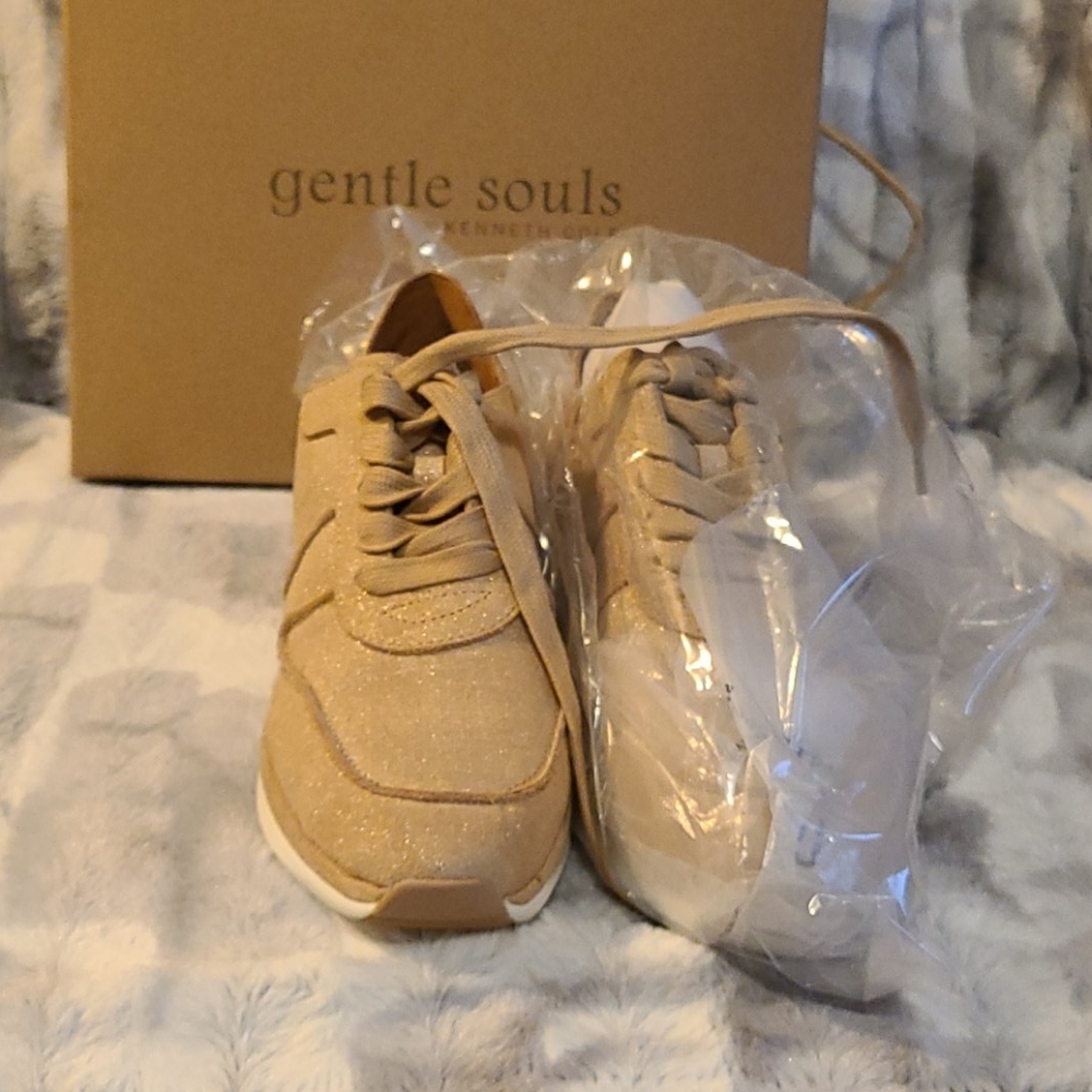 Tan sneakers with a shimmery gold tint